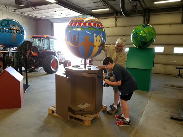 Students fabricating artist designed food libraries in Waverly